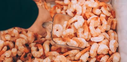 hand picking up prawns