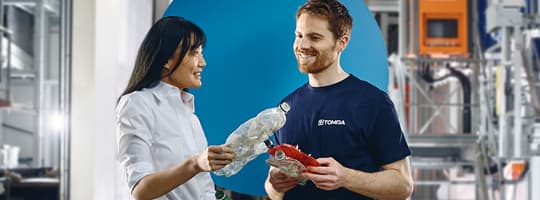 TOMRA-ansatte med returnert plastflaske
