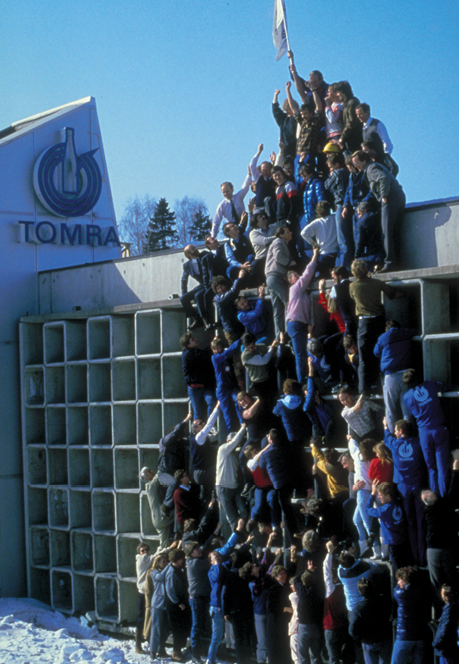Historical photo of TOMRA team climbing building