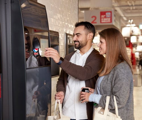 Menschen, die einen Leergutrücknahme-Automat verwenden