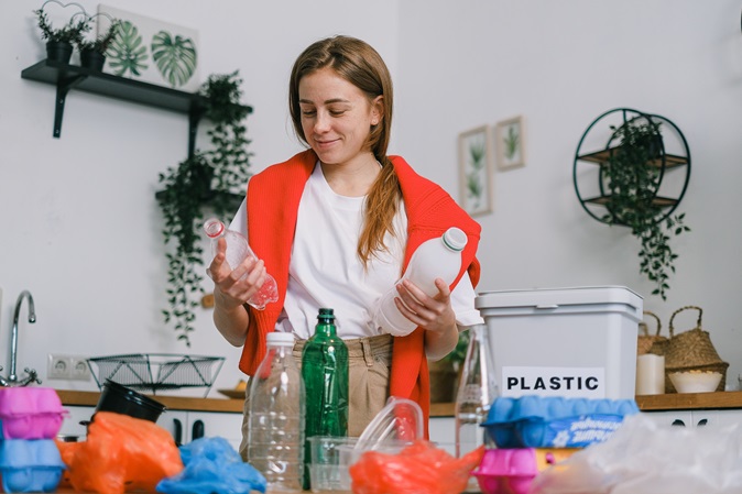 image of a woman sorting bottles at home