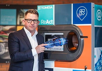image of a man with a reverse vending machine