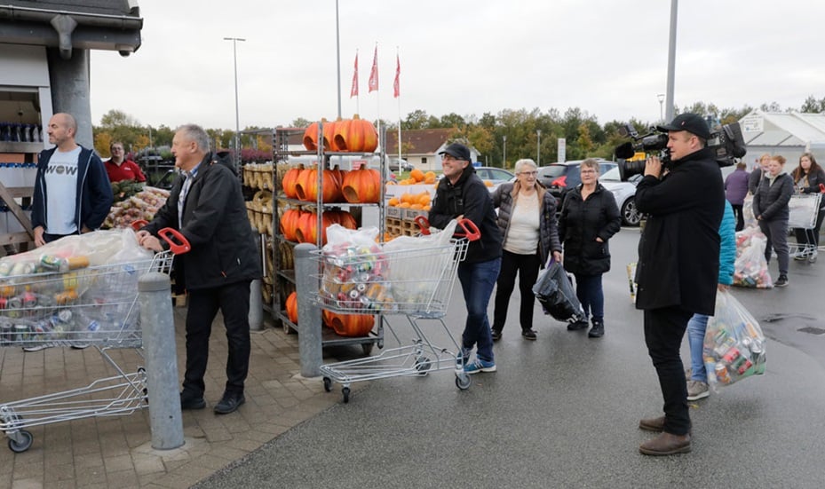 image of people on cue for recycling