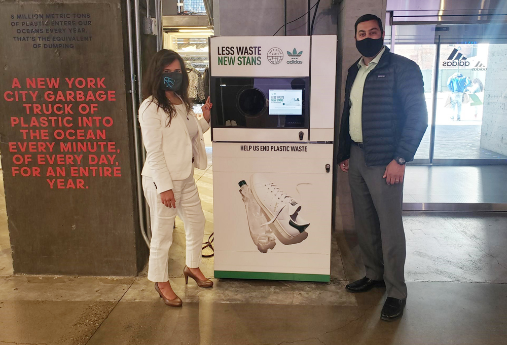 image of a man and a woman standing in front of a reverse vending machine