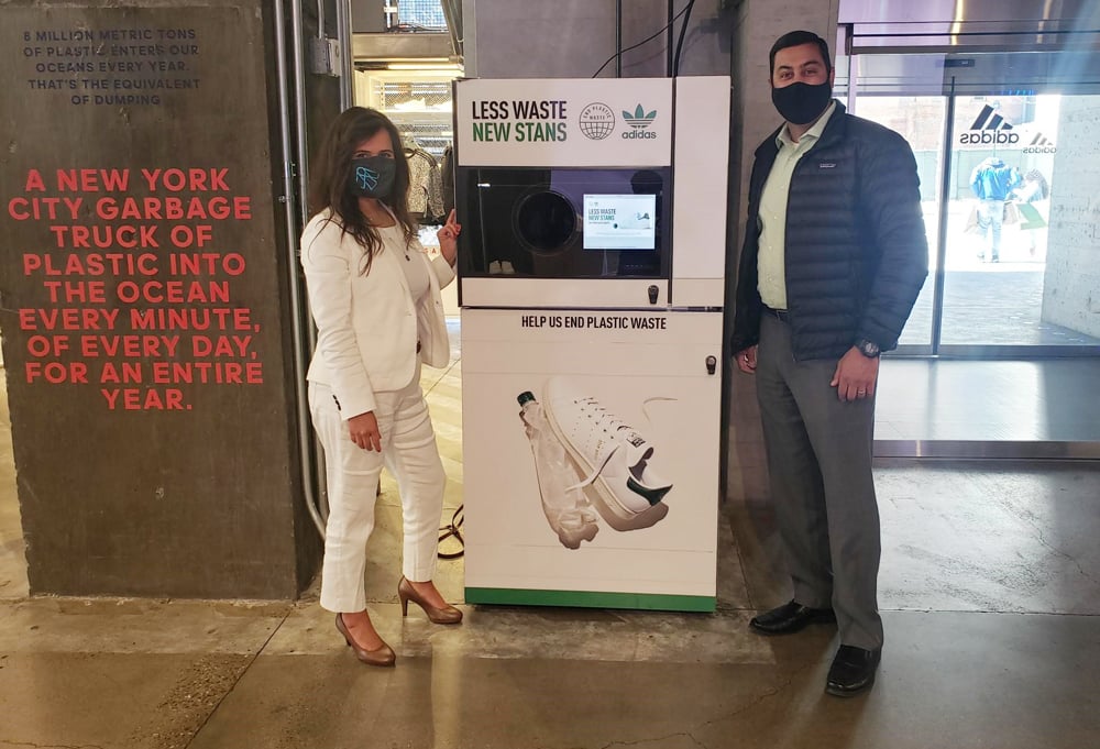 image of a man and a woman standing in front of a reverse vending machine