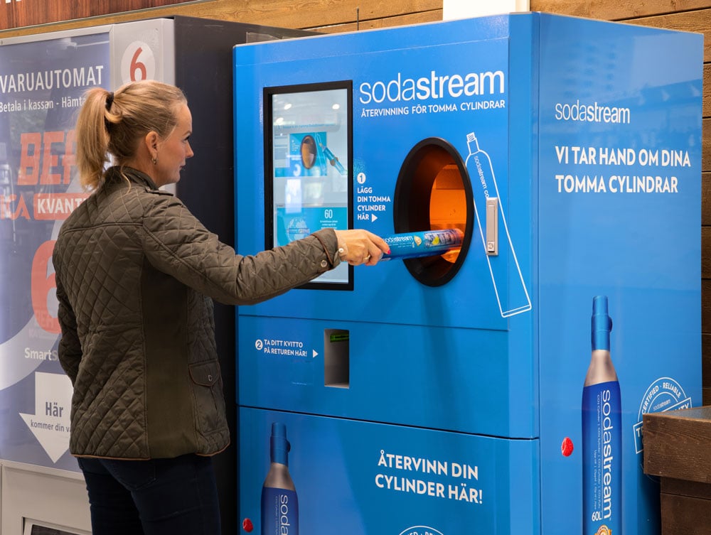 a woman and a reverse vending machine