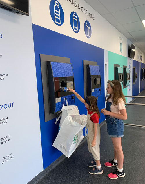 kids using a reverse vending machine