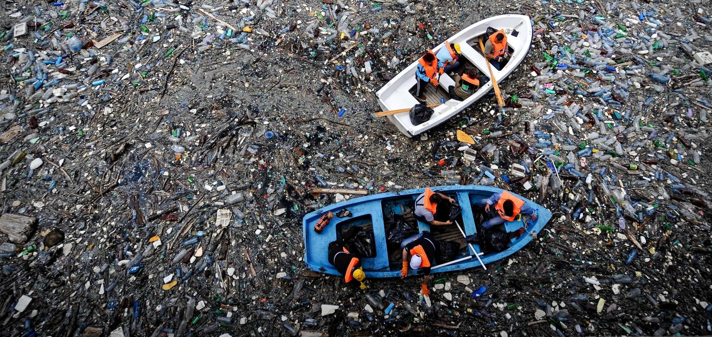 Boats in dam of plastic pollution