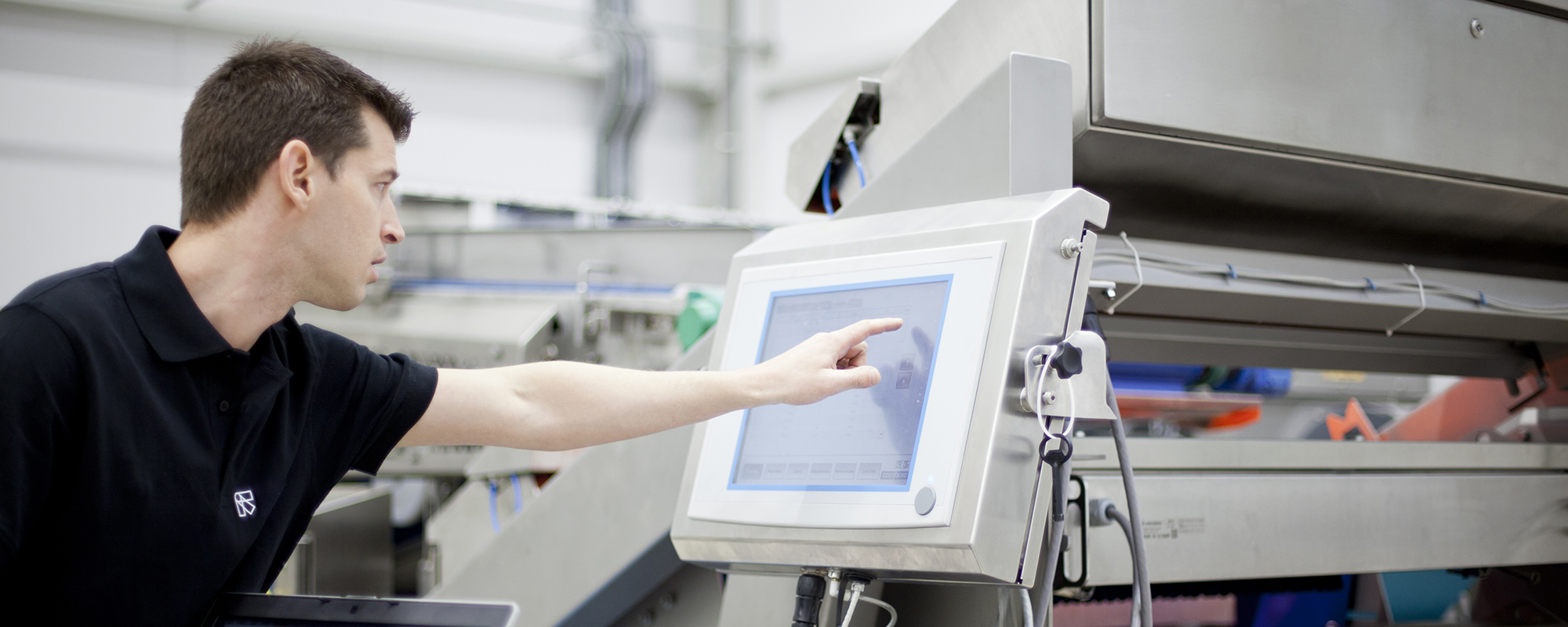 TOMRA service technician operating sorting machine interface