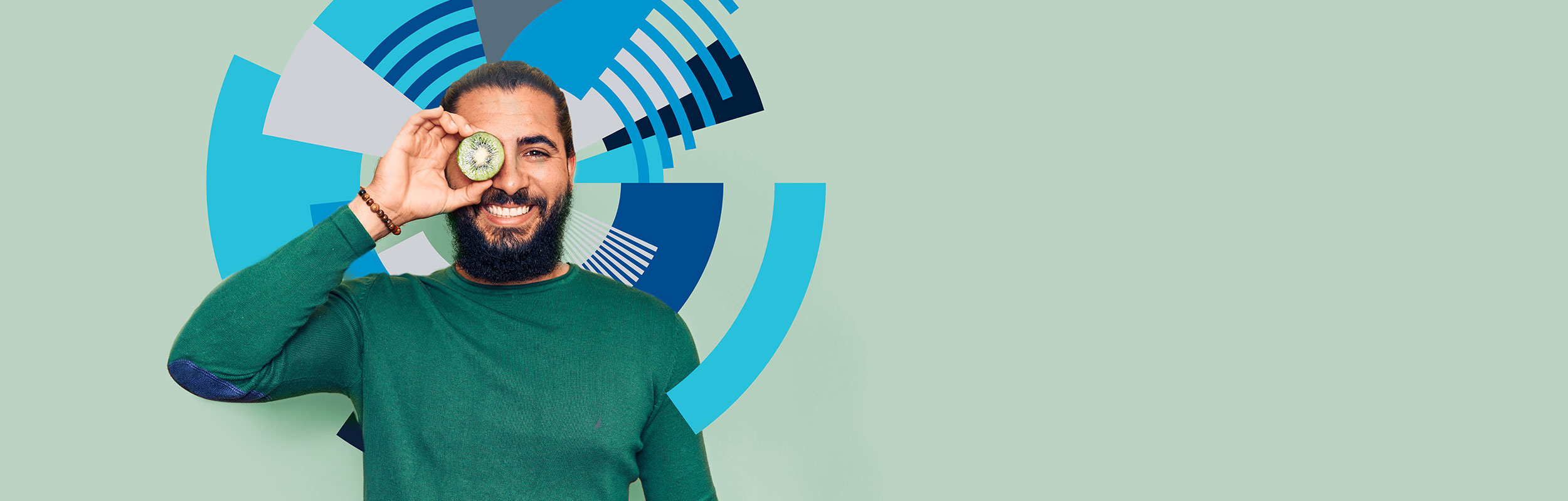 Man holding Kiwi in front of eye