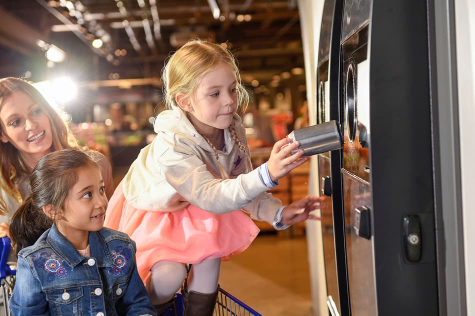 Girls returning empties in Reverse Vending machine