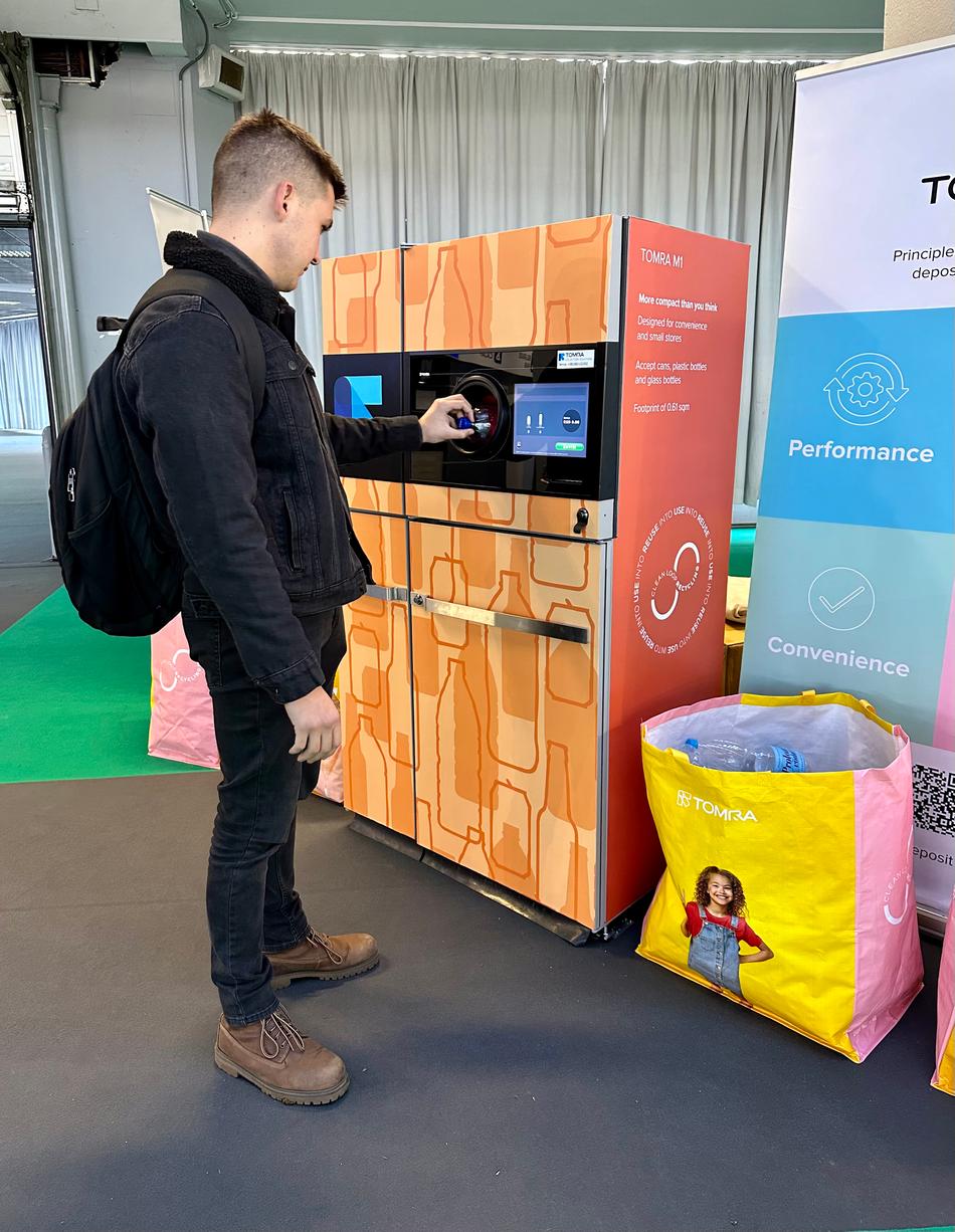 Man using a reverse vending machine