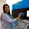 Woman putting a bottle in a reverse vending machine