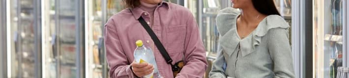 Couple looking at plastic bottle label