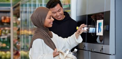 Image of consumers returning containers to reverse vending machine