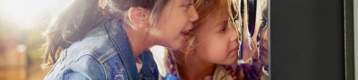 Girls looking into reverse vending machine