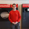 Man in front of reverse vending machine