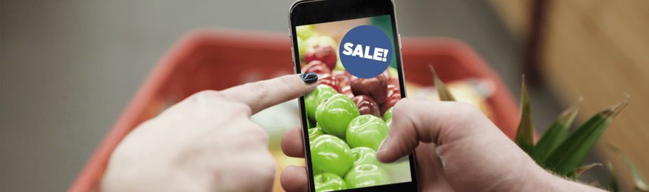 person holding a phone with a screen sign that says sales