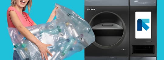 smiling blonde woman with bag of used beverage containers uses a TOMRA R1 reverse vending machine
