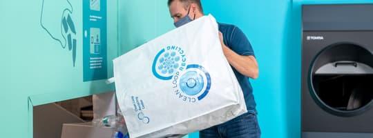 Man pouring out containers for recycling