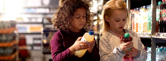 Girls looking at bottles in store