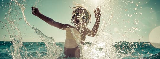 Child playing in ocean