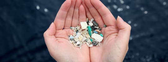 Hands holding microplastics