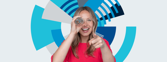 Woman looking through an empty bottle in front of the TOMRA Orbit