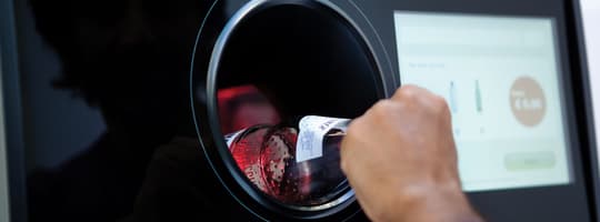 Glass bottle being returned for recycling