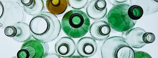 Overhead view of empty plastic bottles of assorted colours