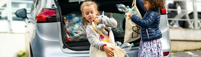 Kids getting containers from car boot