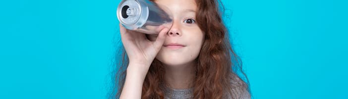 Girl holding beverage can up to eye like a periscope