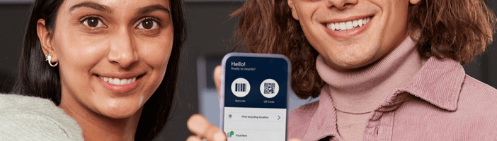 Couple holding phone showing TOMRA digital tools
