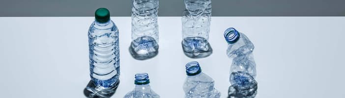 A circle of plastic bottles at various stages of being crushed