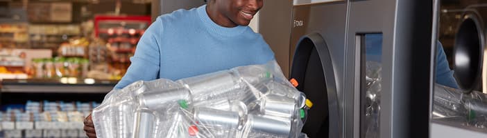 Man using TOMRA R1 reverse vending machine