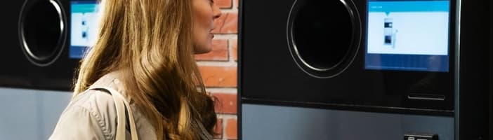 woman using TOMRA T9 reverse vending machine