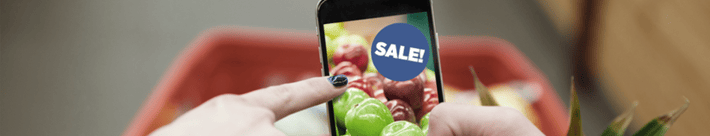 person holding a phone with a screen sign that says sales