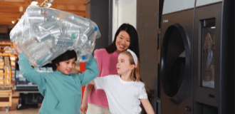 Image of recyclers at reverse vending machine