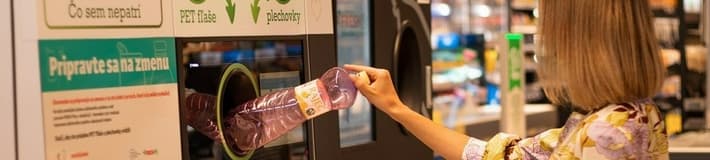 image of a lady feeding bottles in the reverse vending machine