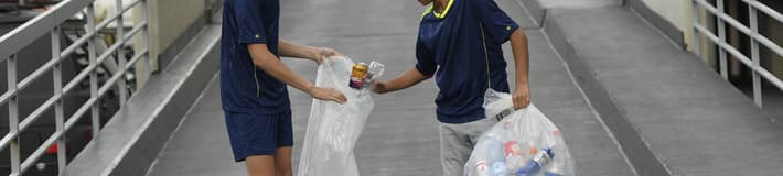 Boys on street with bags of recycling