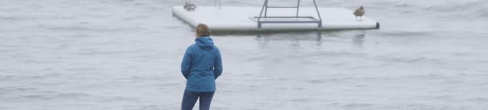 Man looking at boats in the ocean