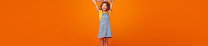 Portrait of a Girl with bag full of bottles in orange background