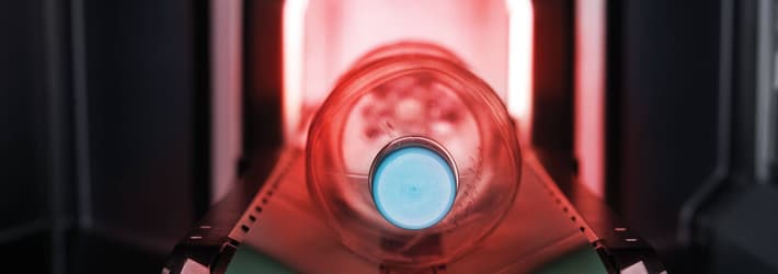 Image of bottle being returned in deposit return schemes set up