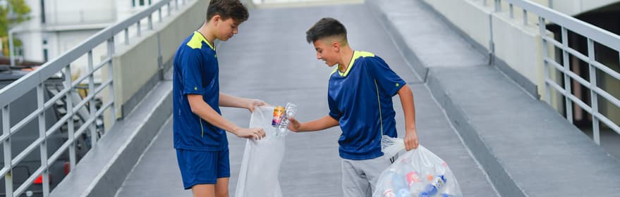 Image of boys picking up containers