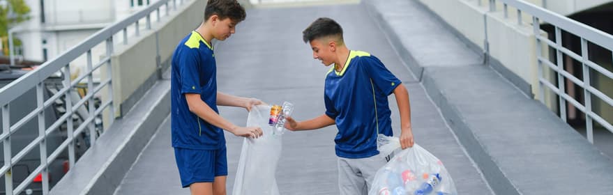 Boys picking up containers