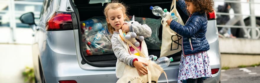 Kids getting containers from car boot