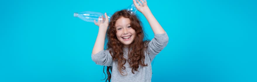 Niña con fondo azul y dos botellas