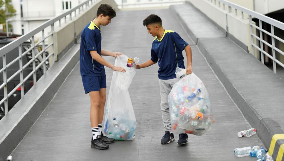 Boys collecting empty bottles