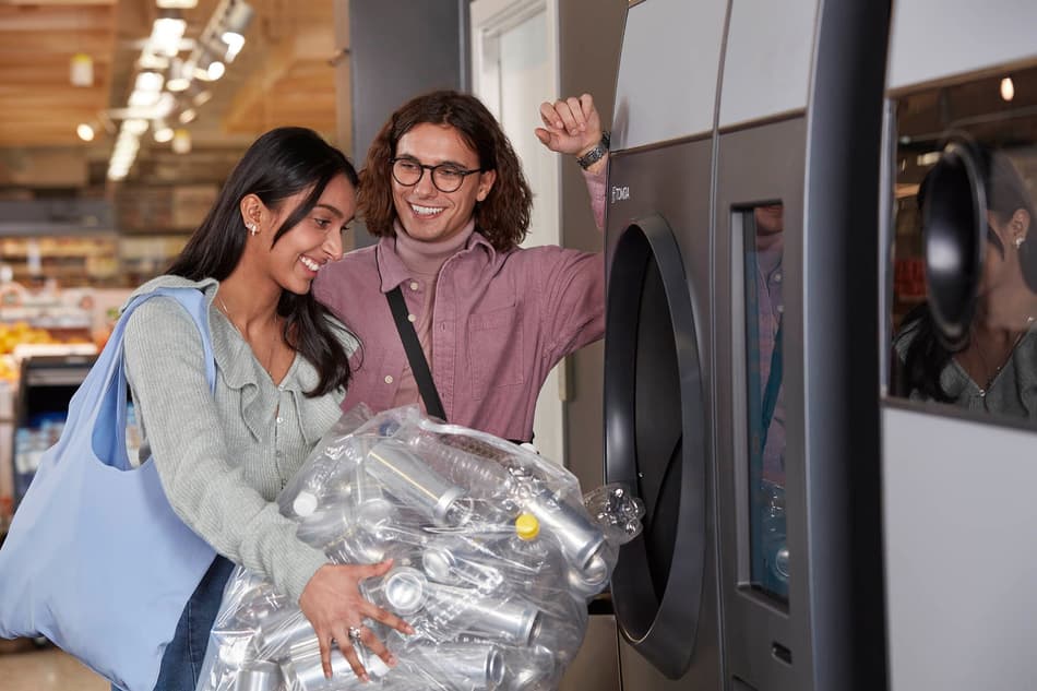 Happy consumers return their used beverage containers at a reverse vending machine