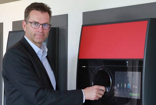 Man in front of reverse vending machine